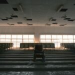 Empty lecture hall with rows of unused seats, illustrating declining college enrollment