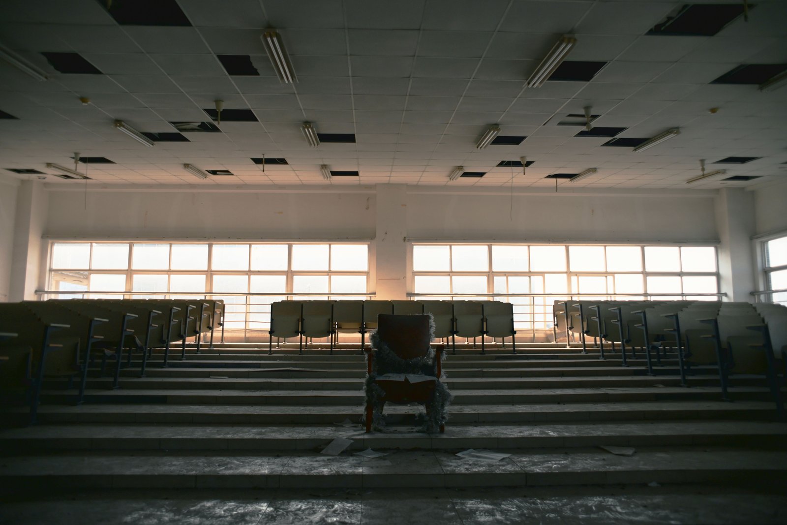 Empty lecture hall with rows of unused seats, illustrating declining college enrollment