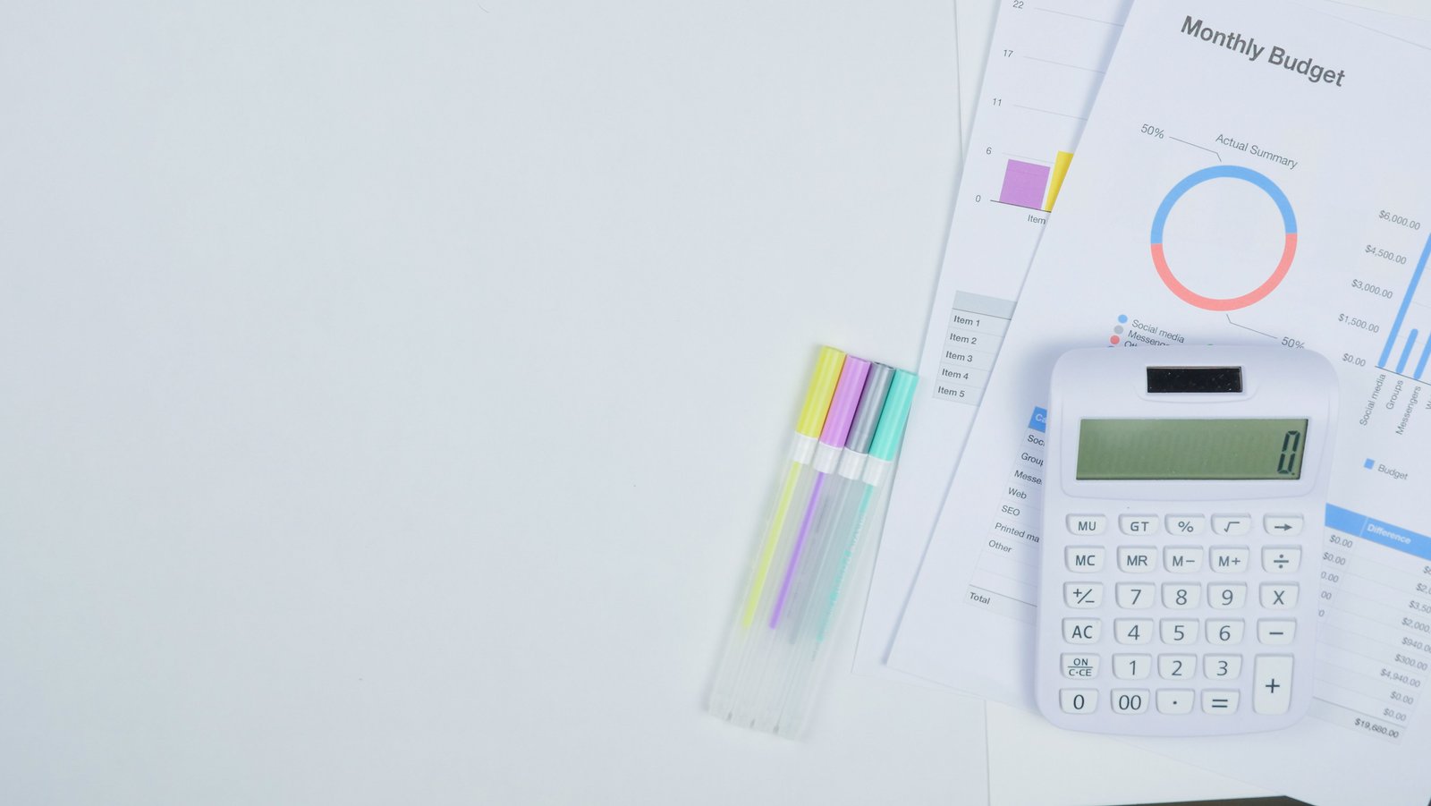 Calculator and budget planning documents on a desk, representing a Salesforce total cost of ownership analysis